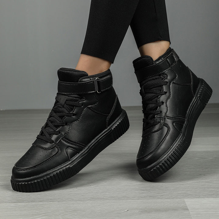 Women’s ankle-high polyurethane leather casual shoe with Velcro cuff, perforated toe cap, and textured rubber sole Mune Fashion