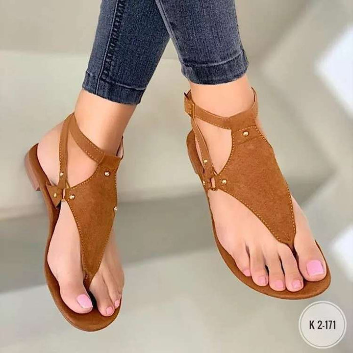 Women’s flat T-strap thong sandals with adjustable ankle strap and decorative floral appliqué in faux leather Mune Fashion