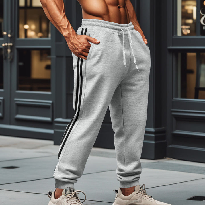 Men's sporty jogging pants with side contrast stripes, elastic drawstring waistband, and ribbed leg endings Mune Fashion