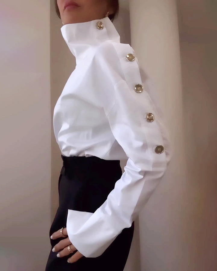 Women high-neck blouse with decorative shoulder buttons and flared cuffs Mune Fashion