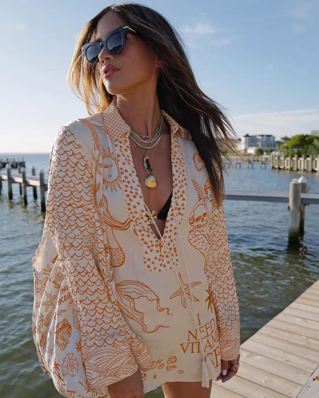 Ladies lightweight beach cover-up in tunic form with deep V-neck, tassel closure, and nautical ocean print Mune Fashion