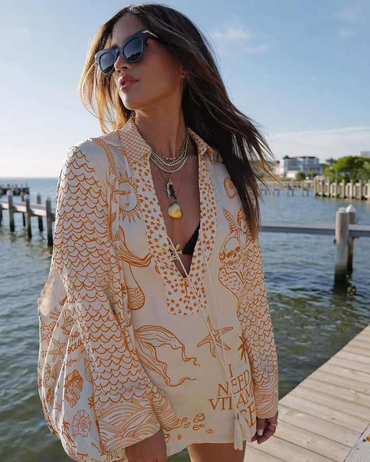 Ladies lightweight beach cover-up in tunic form with deep V-neck, tassel closure, and nautical ocean print Mune Fashion