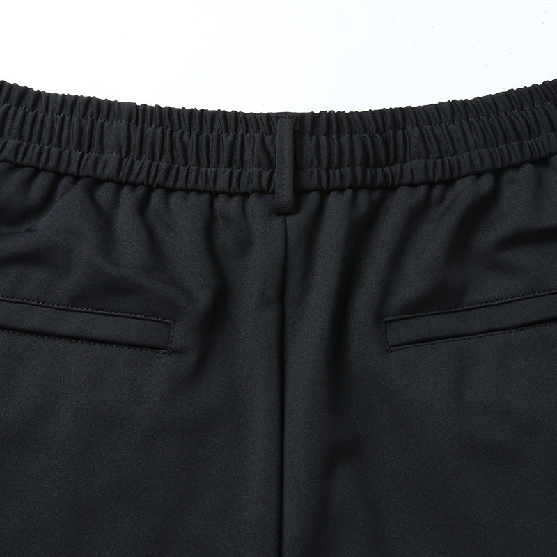 Men's leisure pants with elastic waistband, tapered cut and zippered pockets Mune Fashion