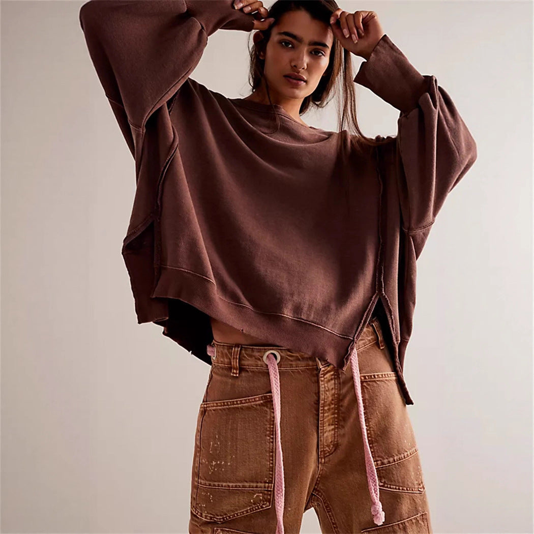 Women's oversized sweatshirt with balloon sleeves, open seam stitches, and side slits Mune Fashion