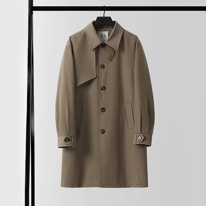 Men's modern minimalist trench coat with asymmetric shoulder flap and knee-length silhouette Mune Fashion