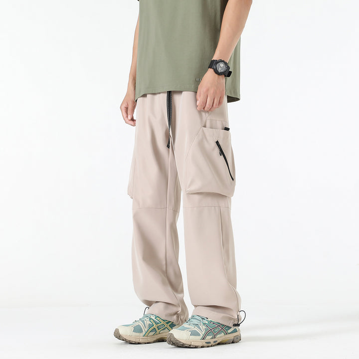 Men's wide cargo pants in baggy style with drawstring waistband, large flap pockets, and adjustable leg openings Drune