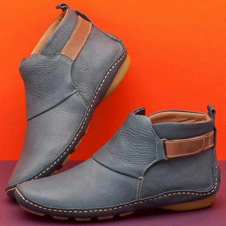 Women's ankle-high slip-on boots made of soft synthetic leather with adjustable hook-and-loop strap and hand-stitched moccasin seam Mune Fashion