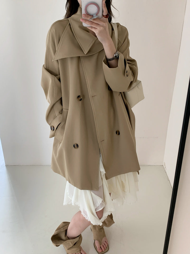 Women’s short trench coat with extra wide lapels, raglan sleeves, and horn button details Mune Fashion