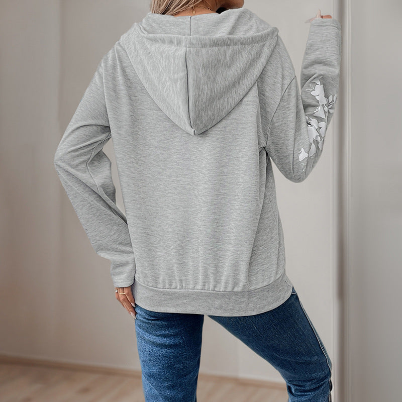 Women's hoodie with half zipper, kangaroo pocket & floral sleeve appliqués Mune Fashion