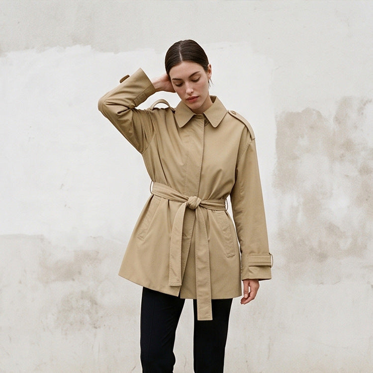 Women's short trench coat with waist belt, shoulder flaps, and adjustable cuffs Mune Fashion