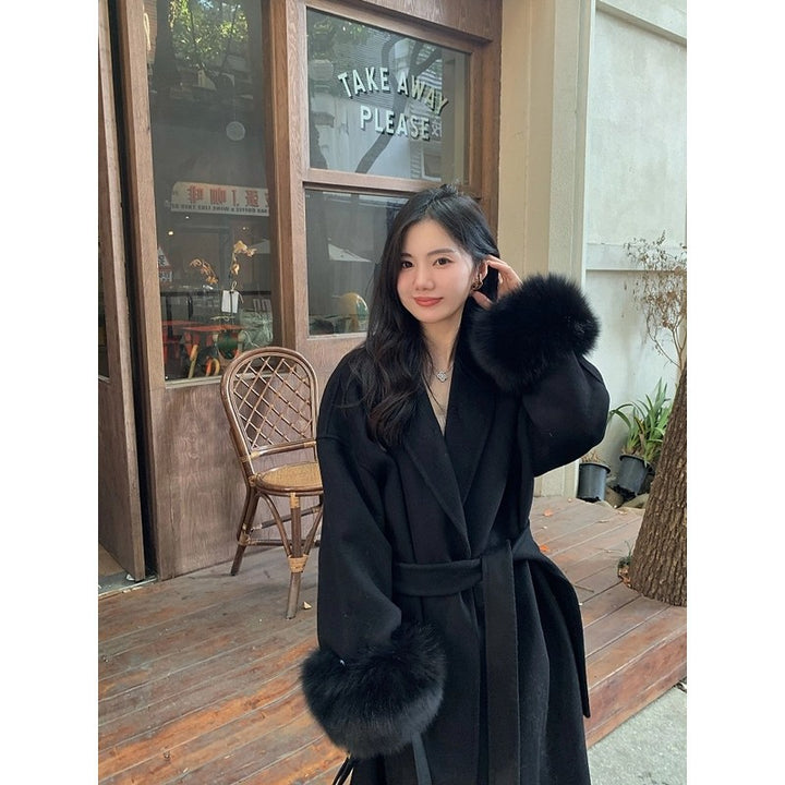 Women's Long Wool Blend Coat with Waist Belt and Voluminous Fur Trim at Sleeve Ends Mune Fashion