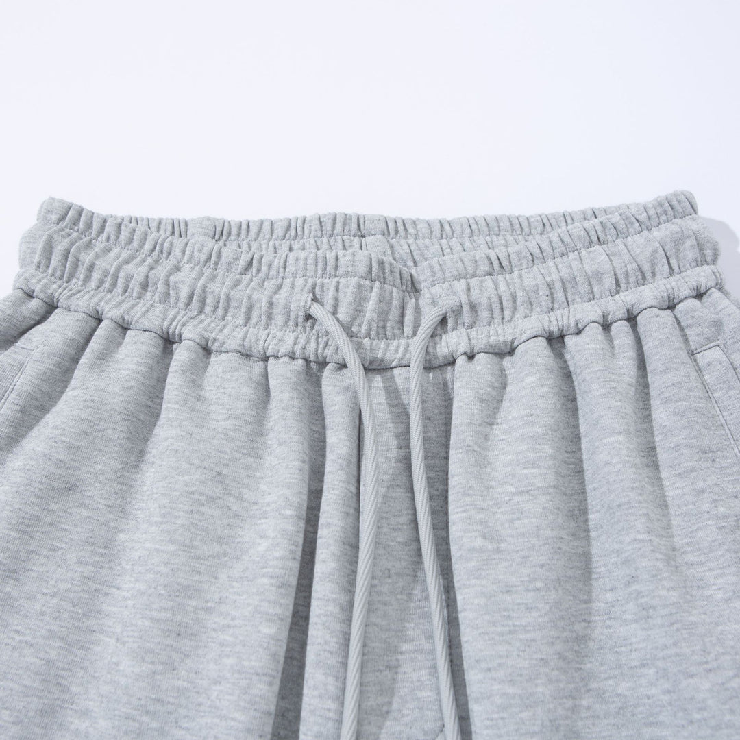 Unisex Wide French-Terry Sweatpants with elastic drawstring waistband, side pockets, and adjustable hem.