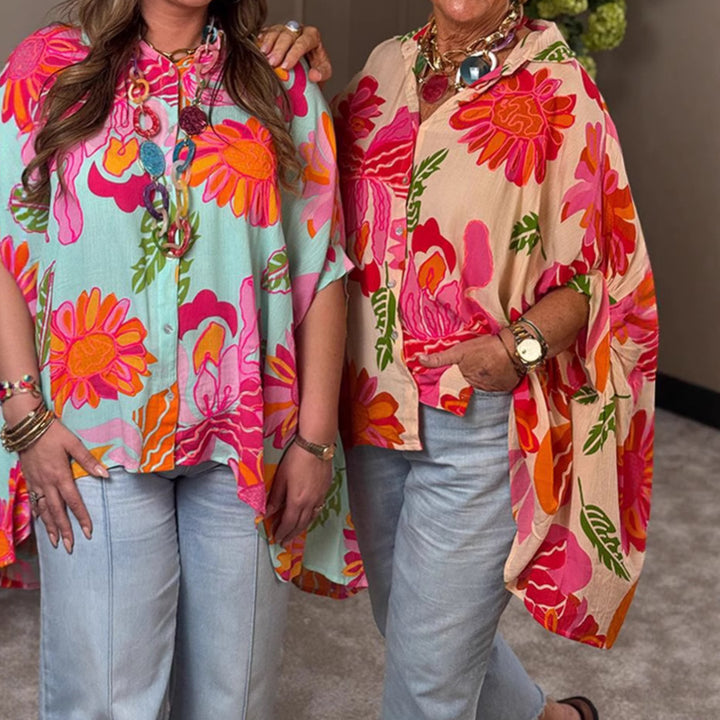 Women's airy oversized resort-style shirt blouse with large floral print and asymmetrical scalloped hem Mune Fashion