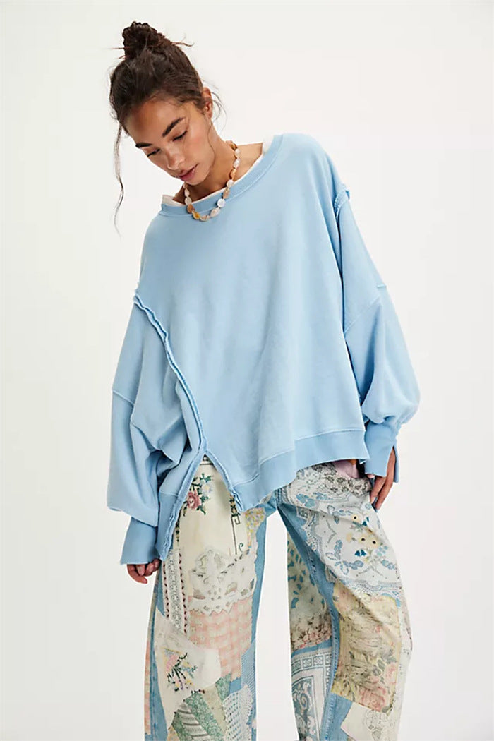 Women's oversized sweatshirt with balloon sleeves, open seam stitches, and side slits Mune Fashion