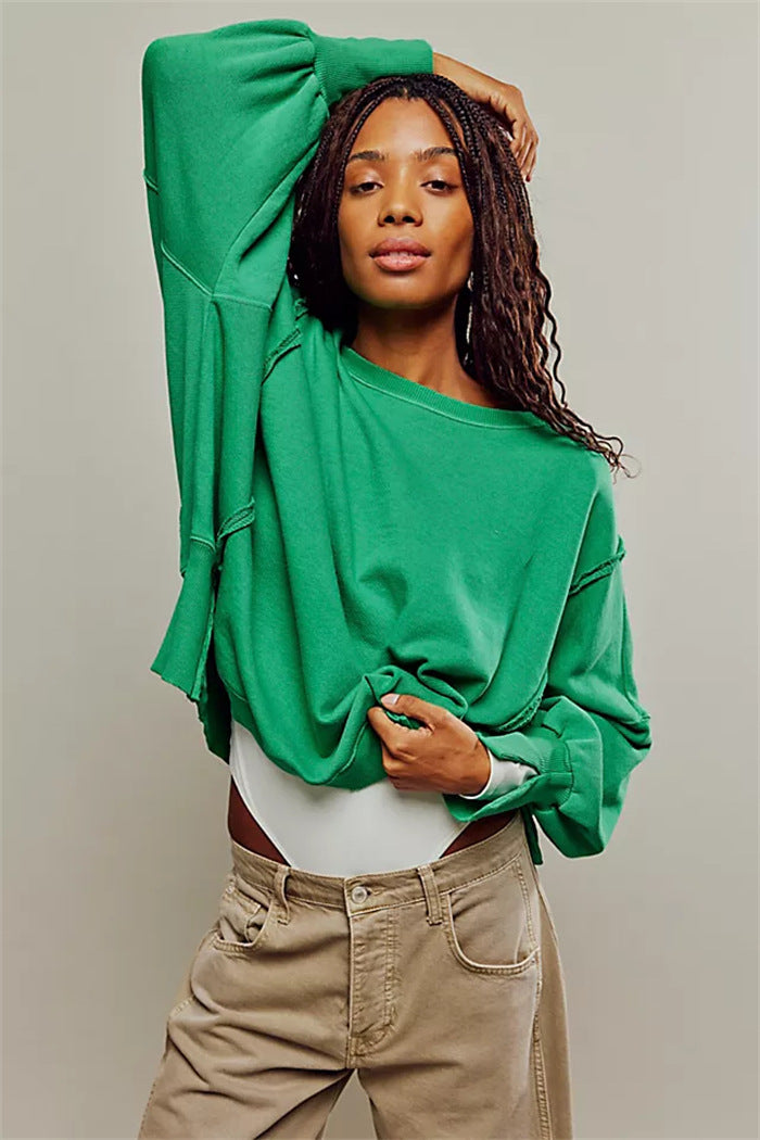 Women's oversized sweatshirt with balloon sleeves, open seam stitches, and side slits Mune Fashion