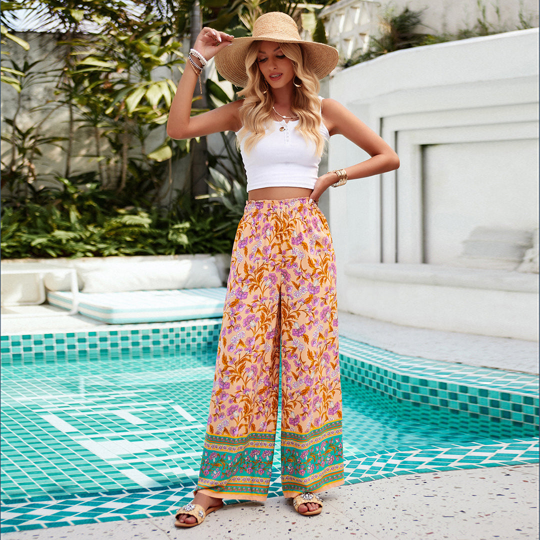 Women's wide Palazzo pants with gathered waistband, side pockets, and floral Boho print Mune Fashion