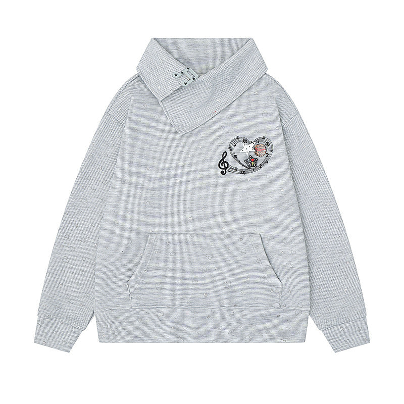 Women’s oversized sweatshirt with asymmetrical stand-up collar, kangaroo pocket and musical heart embroidery Mune Fashion