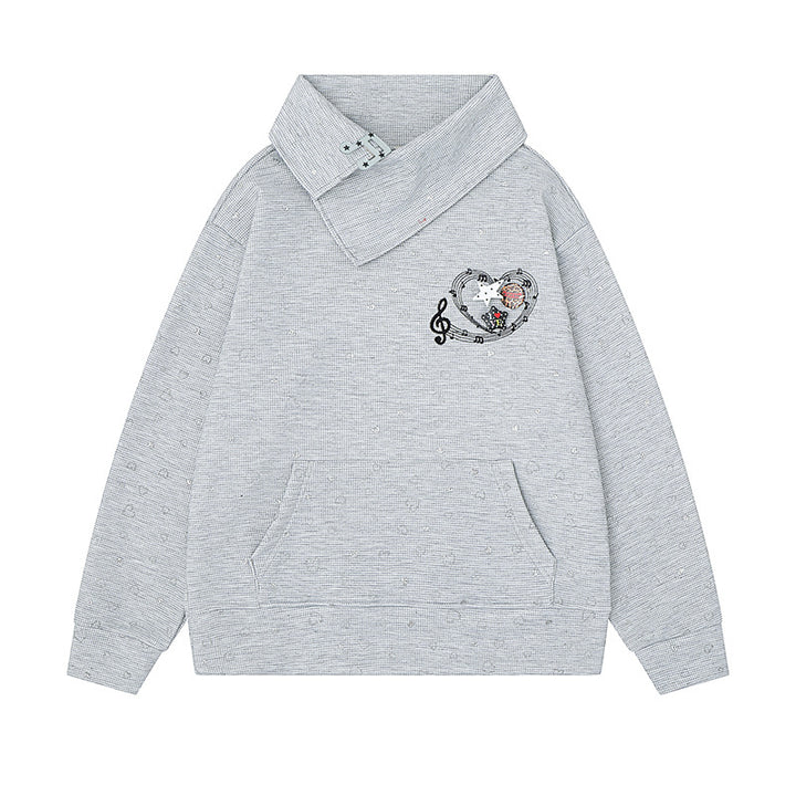 Women’s oversized sweatshirt with asymmetrical stand-up collar, kangaroo pocket and musical heart embroidery Mune Fashion
