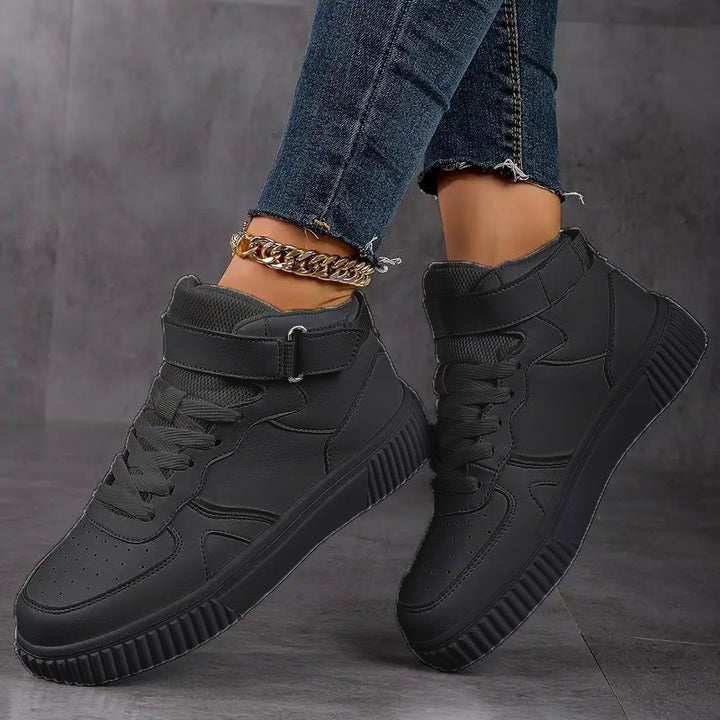 Women’s ankle-high polyurethane leather casual shoe with Velcro cuff, perforated toe cap, and textured rubber sole Mune Fashion