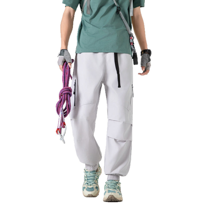 Men's loose technical cargo jogger pants with elastic drawstring waistband, patch flap pockets, and zippered leg pocket Drune