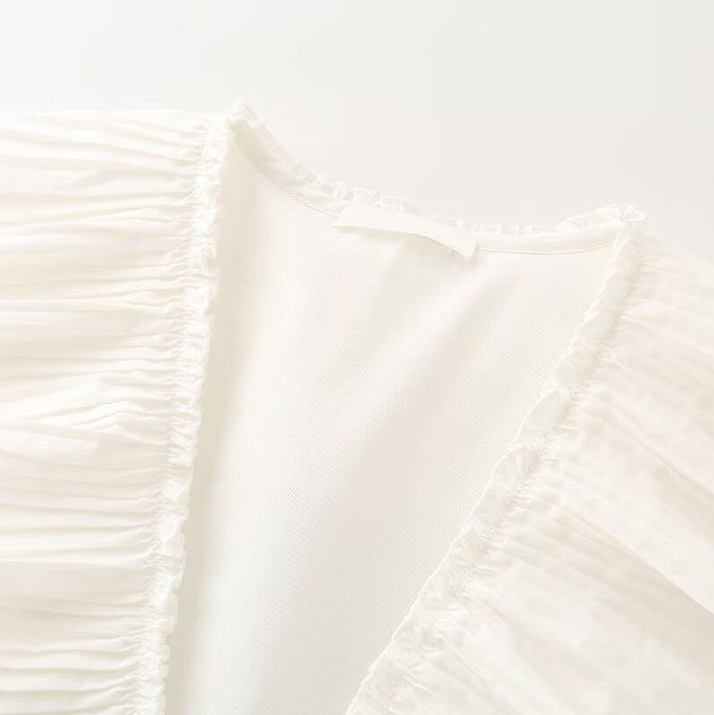 Ladies sleeveless ruffle blouse with deep V-neck, delicate pleated ruffle and tie bow detail