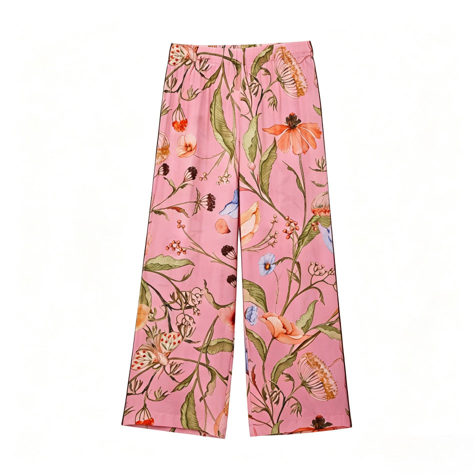 Women's wide high-waisted satin pants with floral all-over print and elastic waistband Mune Fashion