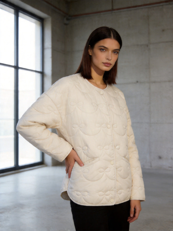 Women’s quilted jacket without collar with decorative bow quilting and snap button closure Mune Fashion