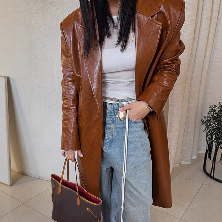 Women's long-cut patent leather trench coat with lapel collar and boxy oversized fit Mune Fashion