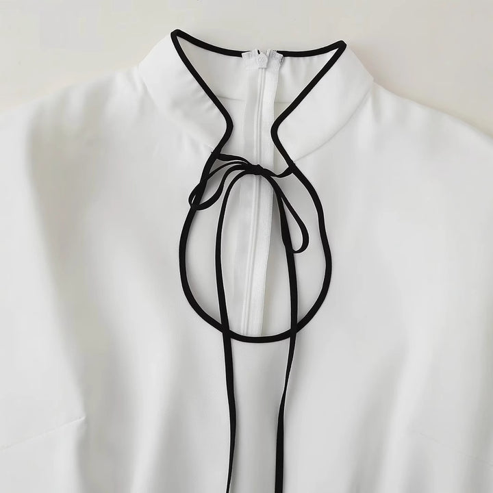 Women's fitted A-line dress with stand collar, bow detail and contrast piping Mune Fashion