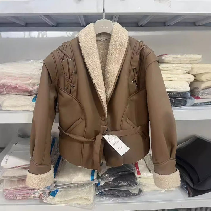 Women's tailored faux leather jacket with Sherpa lining, wrap belt, and side lacing details Mune Fashion