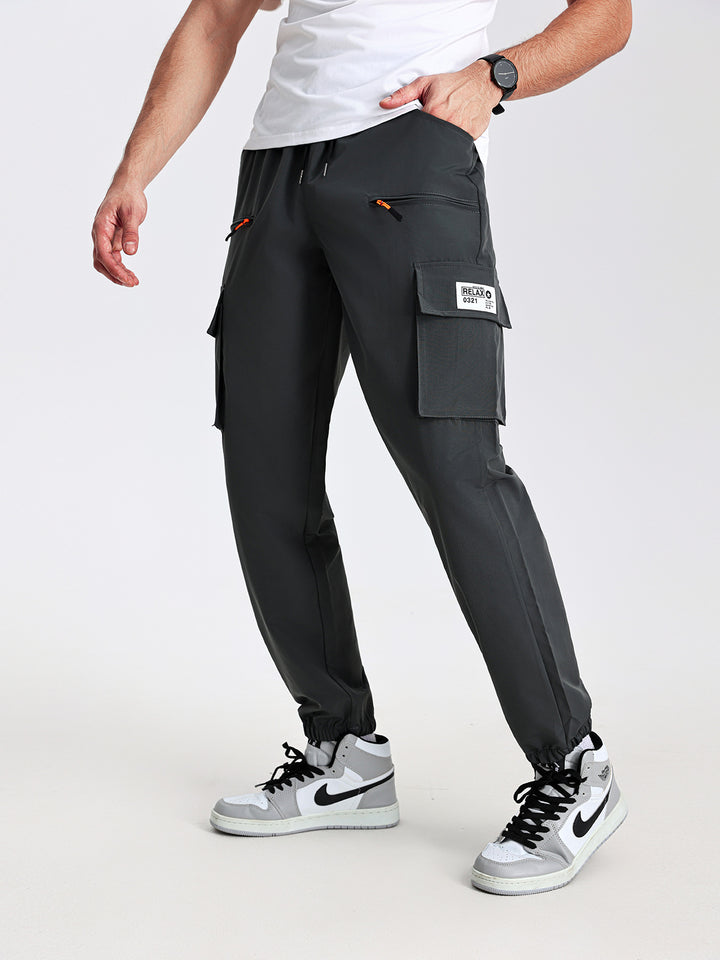Men's tapered cut utility cargo pants in jogger style with drawstring waistband, zippered pockets & elastic leg cuffs Mune Fashion