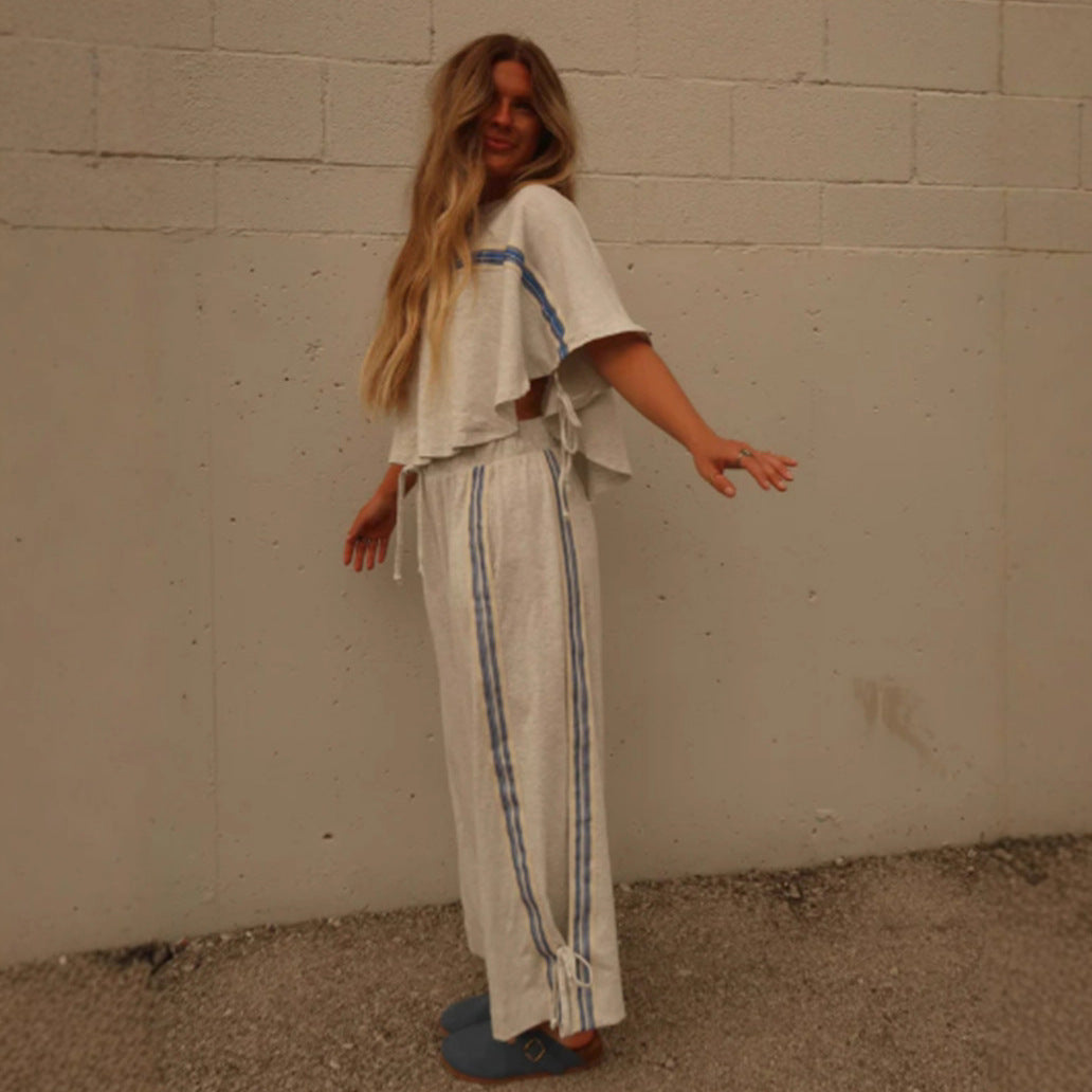 Ladies two-piece leisure ensemble with boxy ruffle top and wide cord pants with side decorative stripe Mune Fashion