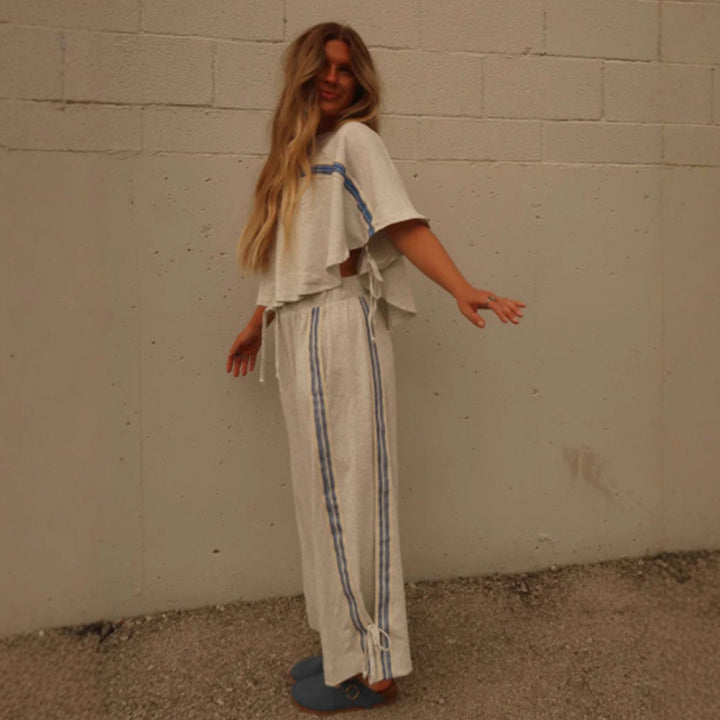 Ladies two-piece leisure ensemble with boxy ruffle top and wide cord pants with side decorative stripe Mune Fashion