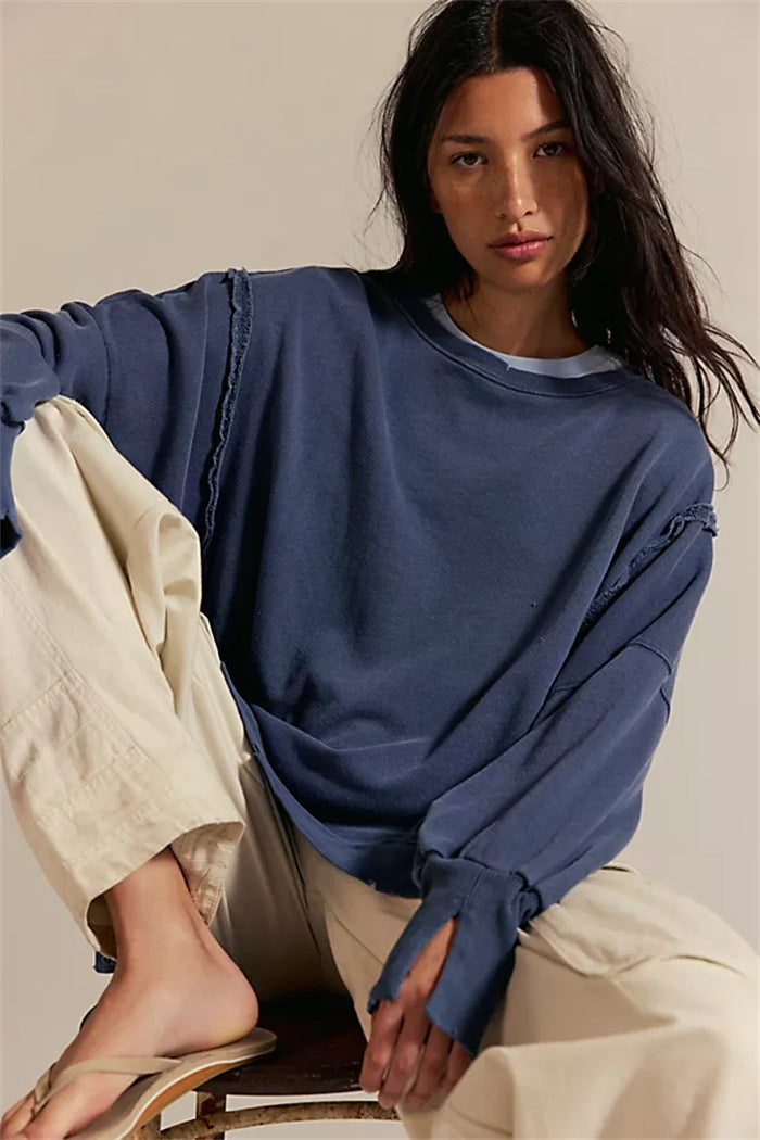 Women's oversized sweatshirt with balloon sleeves, open seam stitches, and side slits Mune Fashion