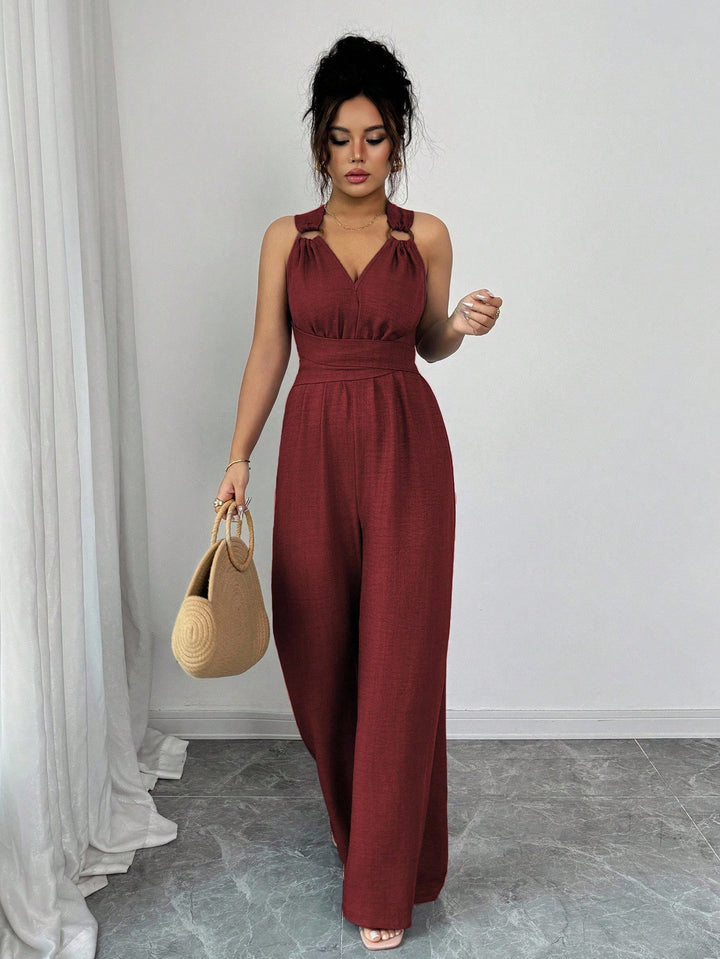Women’s jumpsuit with wide leg, tailored wrap belt and eyelet straps Mune Fashion