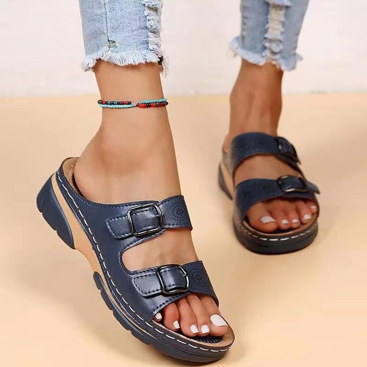 Women's double-strap slide with laser perforation, adjustable metal buckles, and padded wedge footbed Mune Fashion