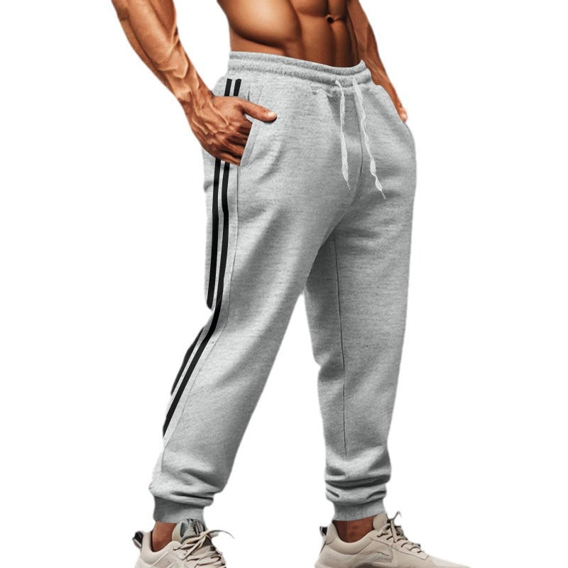 Men's sporty jogging pants with side contrast stripes, elastic drawstring waistband, and ribbed leg endings Mune Fashion