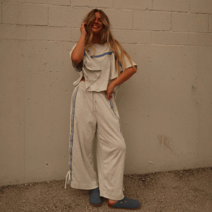 Ladies two-piece leisure ensemble with boxy ruffle top and wide cord pants with side decorative stripe Mune Fashion
