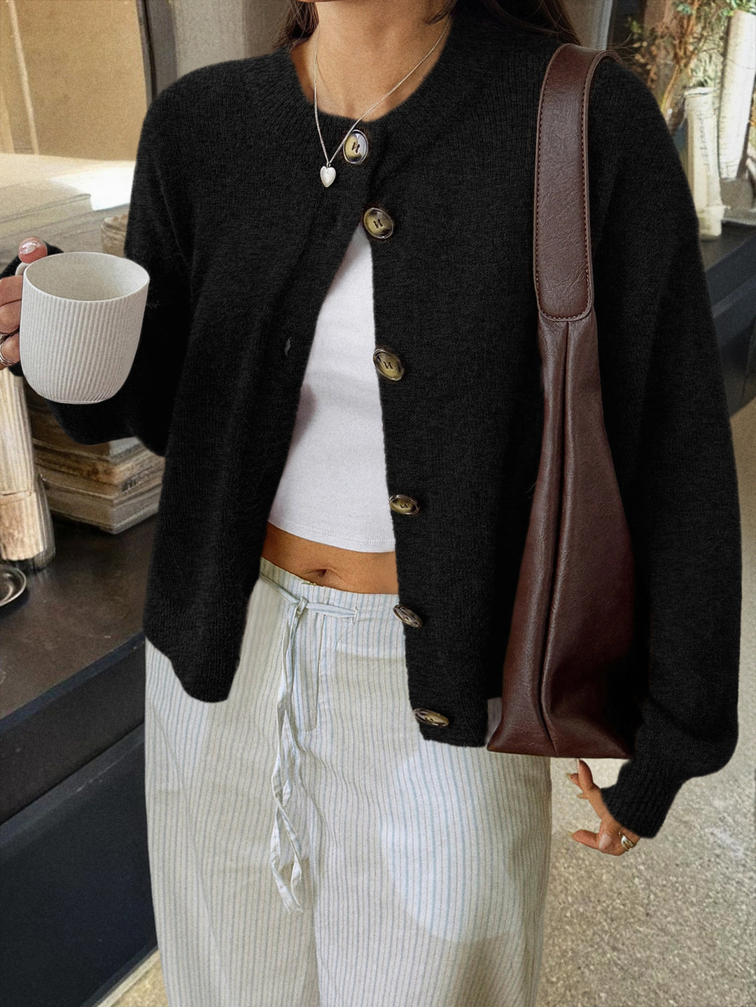 Women's cozy oversized knitted cardigan with horn button placket and round neckline Mune Fashion