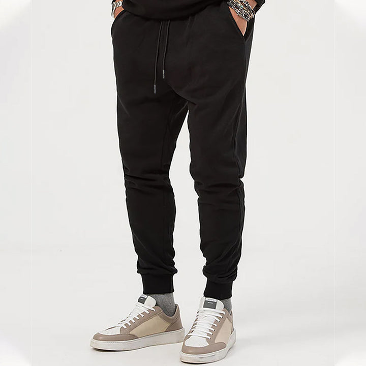 Men's jersey sweatpants in a tapered cut with concealed drawstring and shape-stable ankle cuffs Mune Fashion