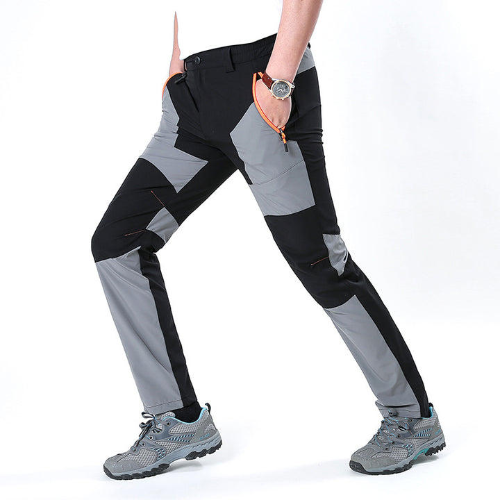 Men's functional trekking pants with reinforced knees, elastic waistband, and zipper pockets.