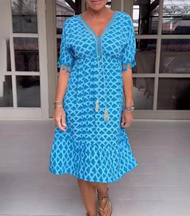 Women's casual midi dress in kaftan style with V-neck, tassel band, gathered empire seam, and fringe sleeves Mune Fashion