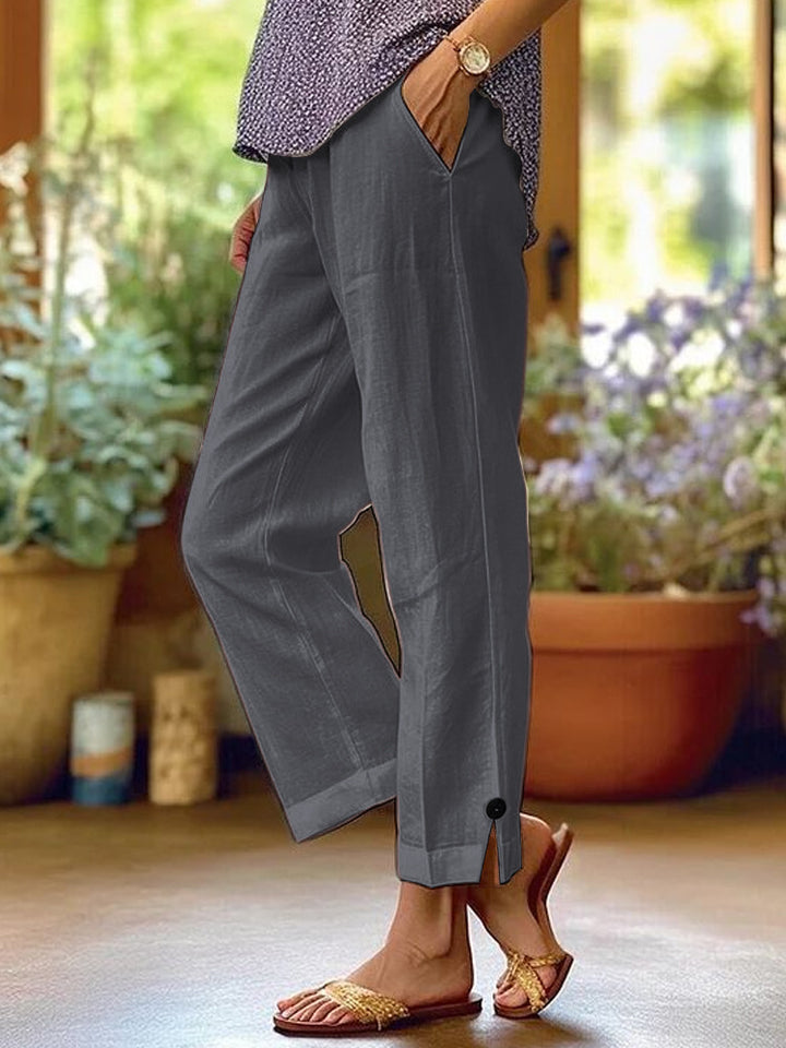 Women's linen trousers with a relaxed, ankle-length fit, side pockets and decorative button details Mune Fashion