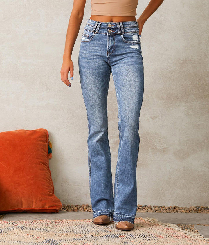 Ladies high-waisted vintage bootcut jeans with double button fly, light destroyed detail, and frayed hem Mune Fashion