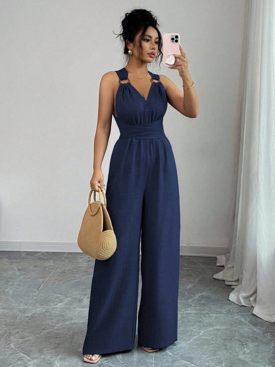 Women’s jumpsuit with wide leg, tailored wrap belt and eyelet straps Mune Fashion