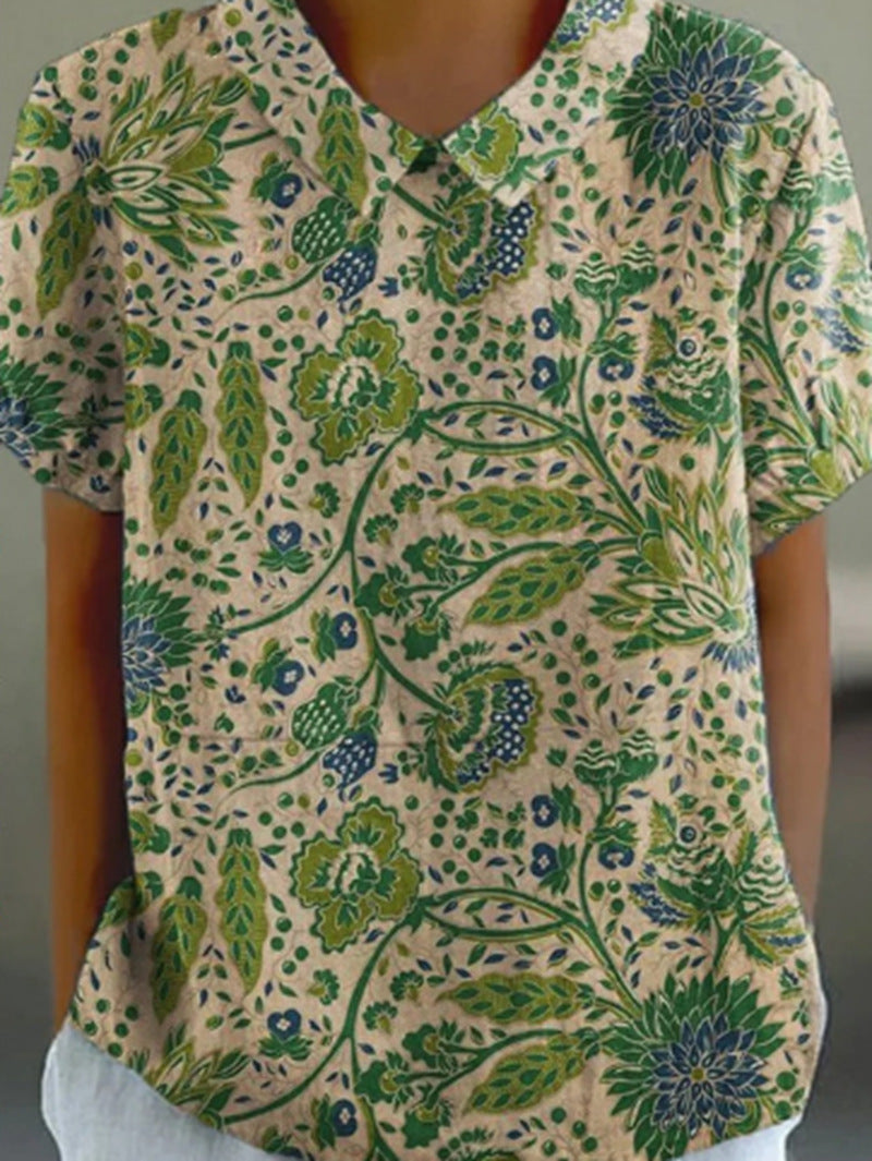 Women's casual short-sleeve blouse with V-neck, rounded hem, and botanical all-over print Mune Fashion