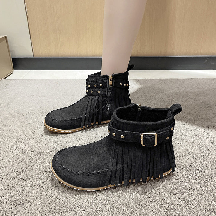 Women's fringe ankle boot in moccasin style with decorative studs, buckle strap, and side zipper Mune Fashion