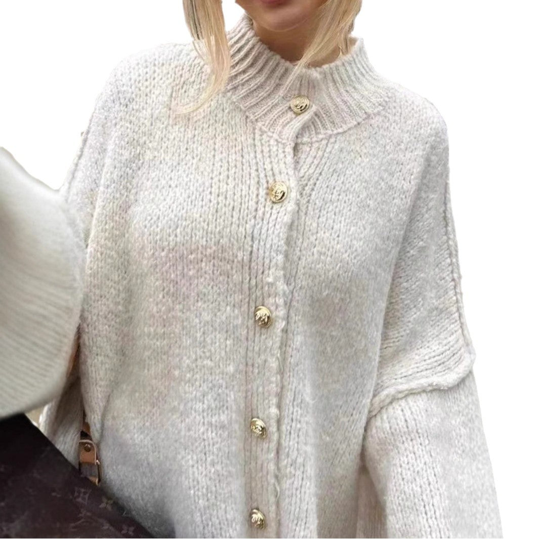 Women’s oversized knit cardigan made of chunky knit with ribbed round neck, dropped shoulders, and wooden button placket.