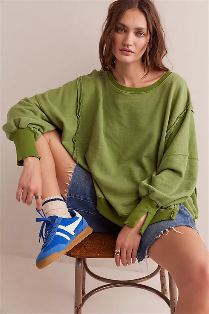 Women's oversized sweatshirt with balloon sleeves, open seam stitches, and side slits Mune Fashion