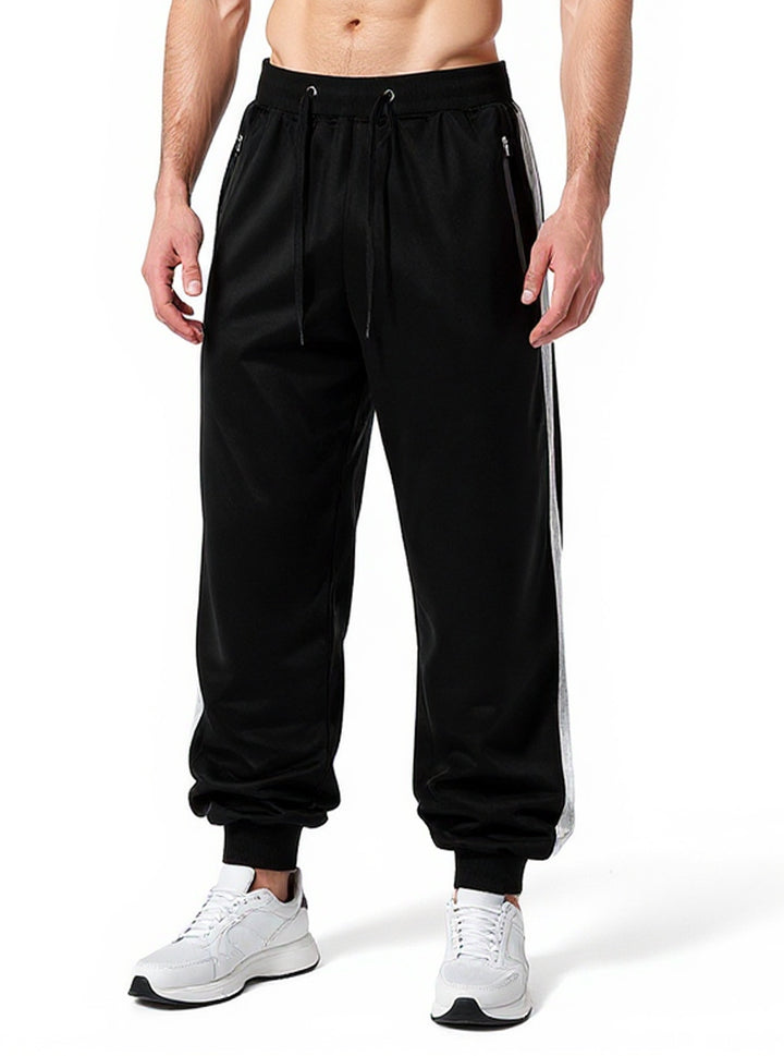 Men's sporty jogging pants with elastic waistband and side zip pockets Mune Fashion